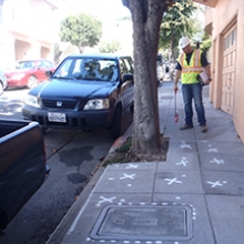 staff inspecting sidewalk